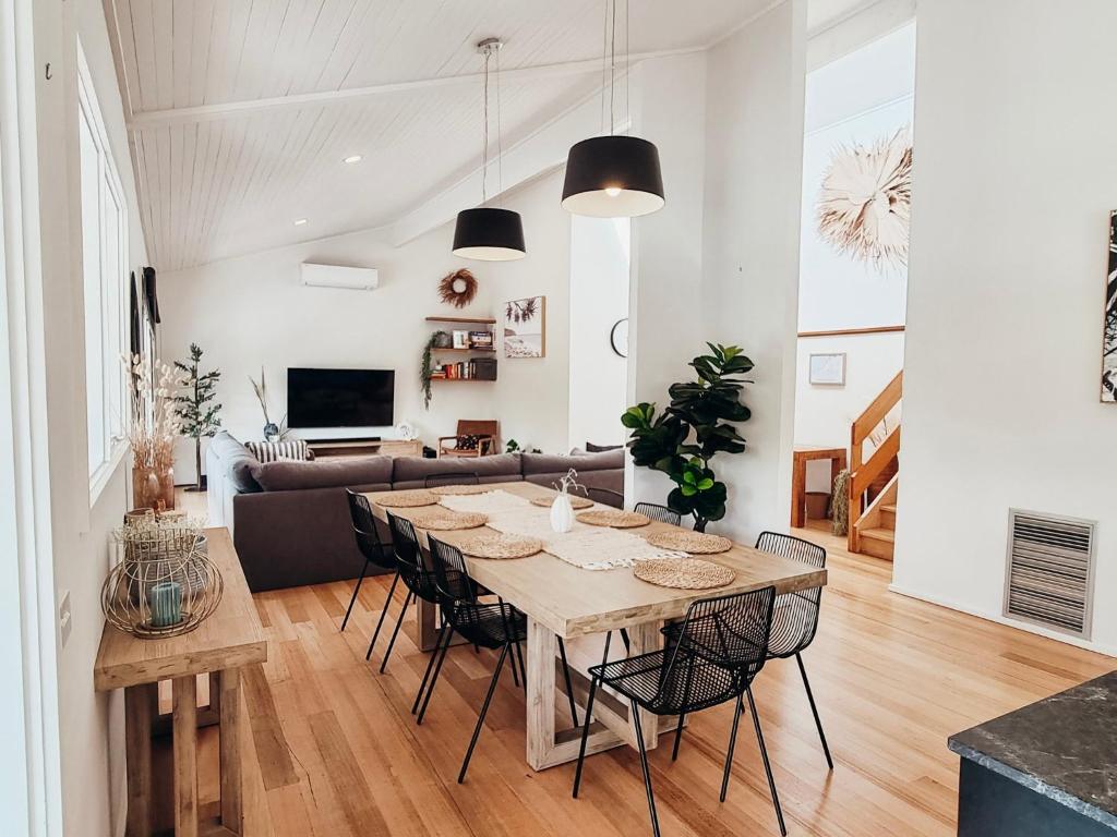 a dining room and living room with a table and chairs at Sea Haven, A Rye Coastal Retreat! in Rye