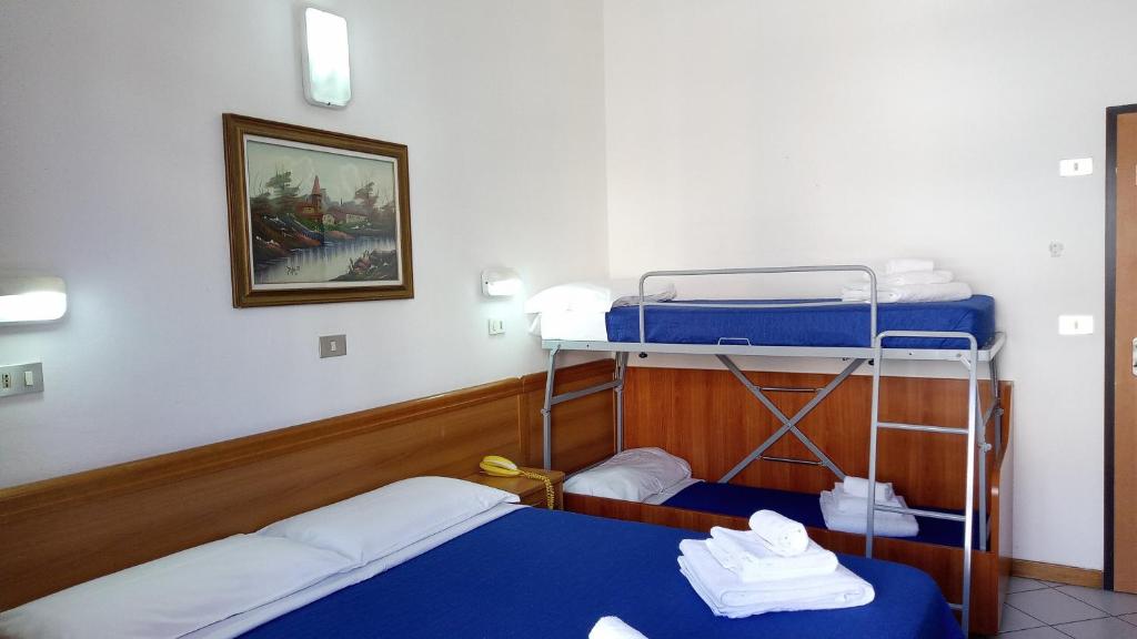 Postel nebo postele na pokoji v ubytování Hotel Venezia Beach
