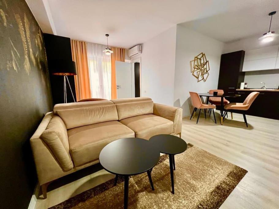 ein Wohnzimmer mit einem Sofa und einem Tisch in der Unterkunft City Center Accommodation - 310 in Reşiţa