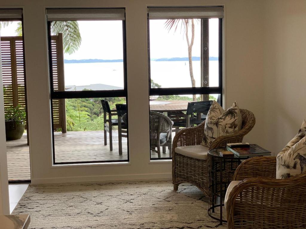 a living room with french doors leading to a deck at Sea Veiws Kaha Place in Russell