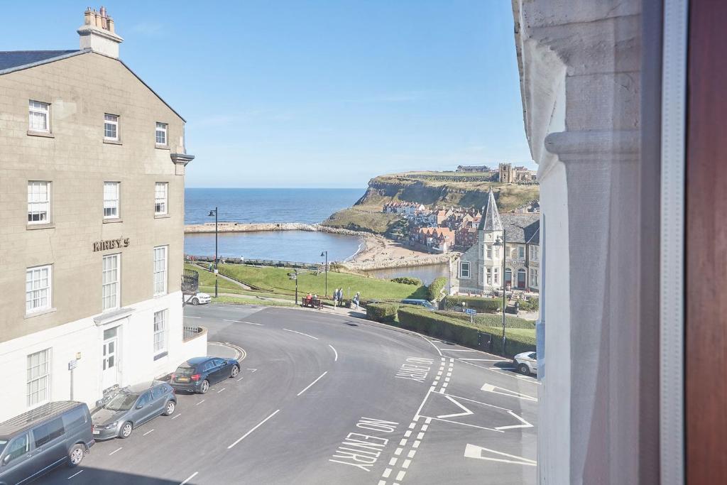a view from a window of a street and the ocean at Apartment 4, Khyber Lodge Apartment Whitby in Whitby