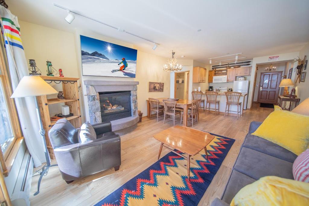 a living room with a couch and a fireplace at Black Bear 8043 in Keystone