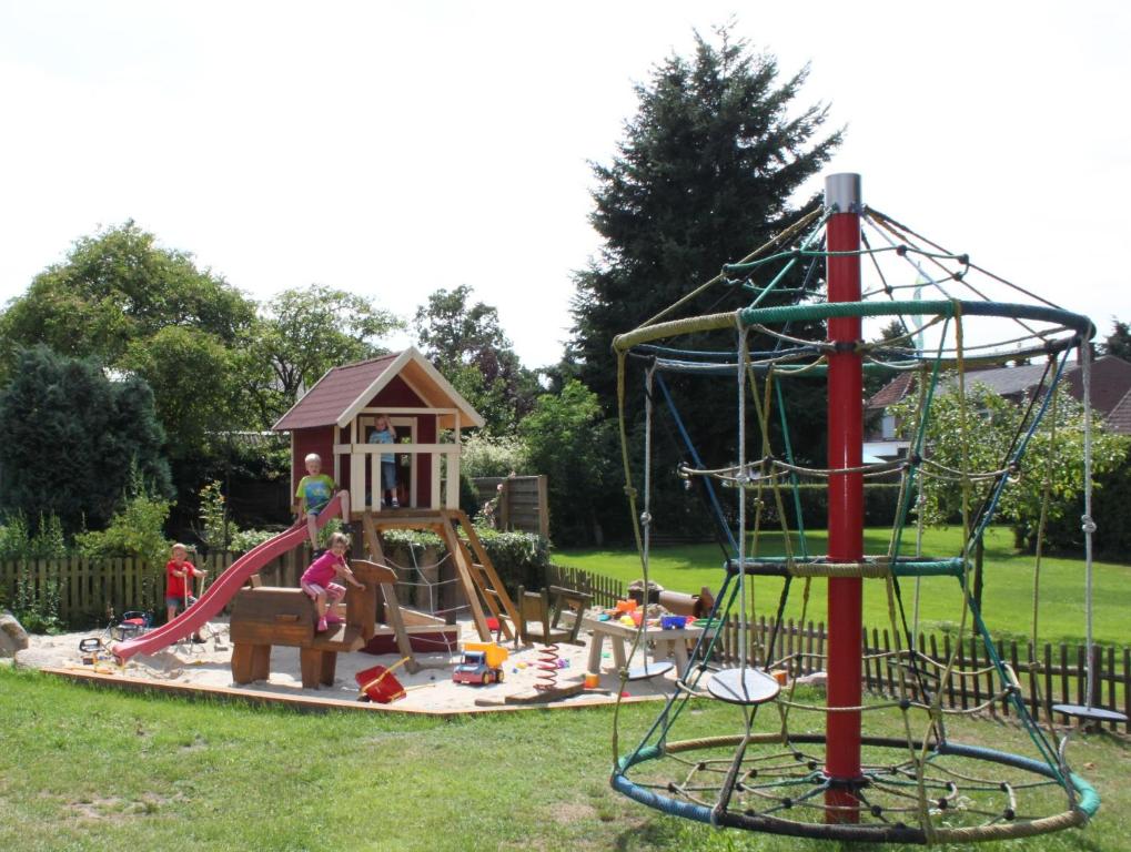 a playground with a slide and a play structure at Ferienhof Stadtländer in Mardorf am Steinhuder Meer in Neustadt am Rübenberge