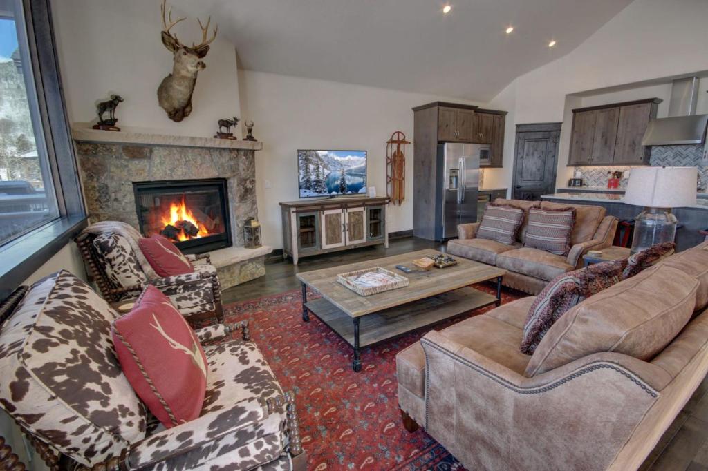 a living room with couches and a fireplace at River Run Townhomes 63 in Keystone