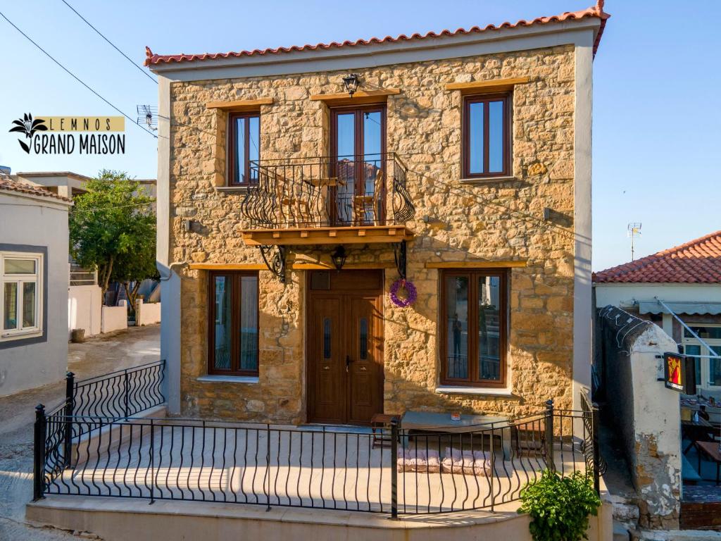 a stone house with a balcony on the front of it at Lemnos grand maison in Kondopoúlion