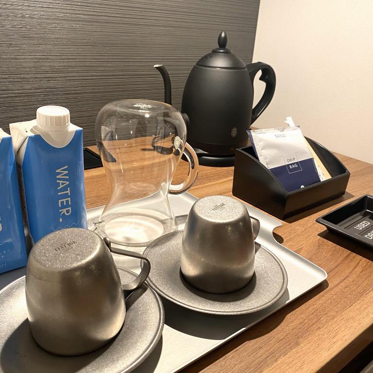 a table with two cups and a teapot on it at HOTEL SAILS in Osaka
