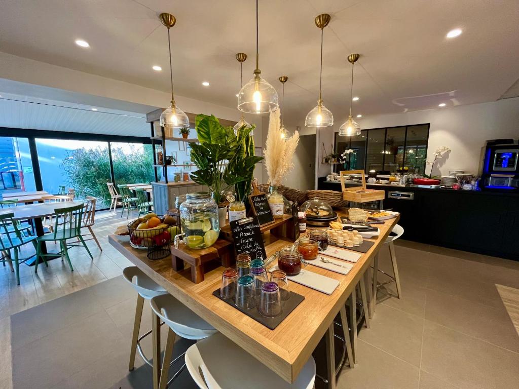 a kitchen with a large table with food on it at Campanile Orange A7/ A9 in Orange