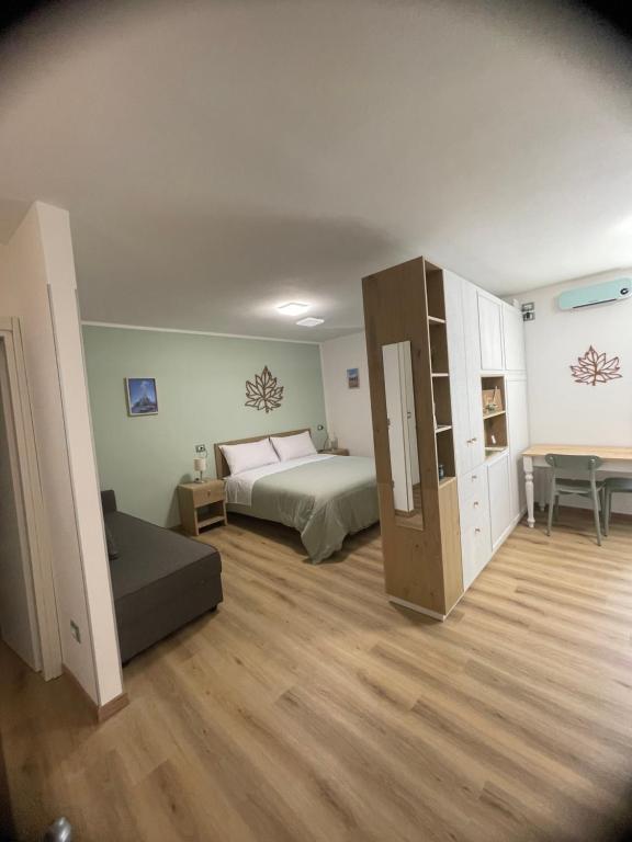 a large room with a bed and a desk at La Foglia in Abbadia San Salvatore