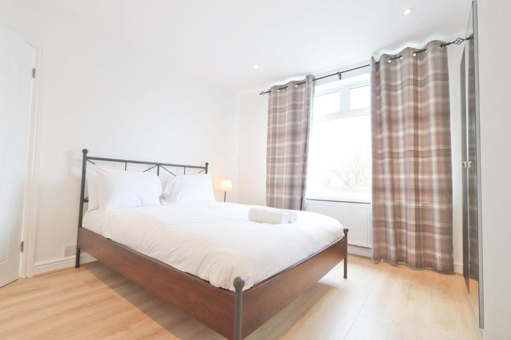 a bedroom with a bed and a window at Lovely 3 bedroom property in Filton in Bristol