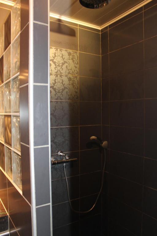 a bathroom with a shower with a hose at Sagardi Zolan in Saint-Jean-de-Luz