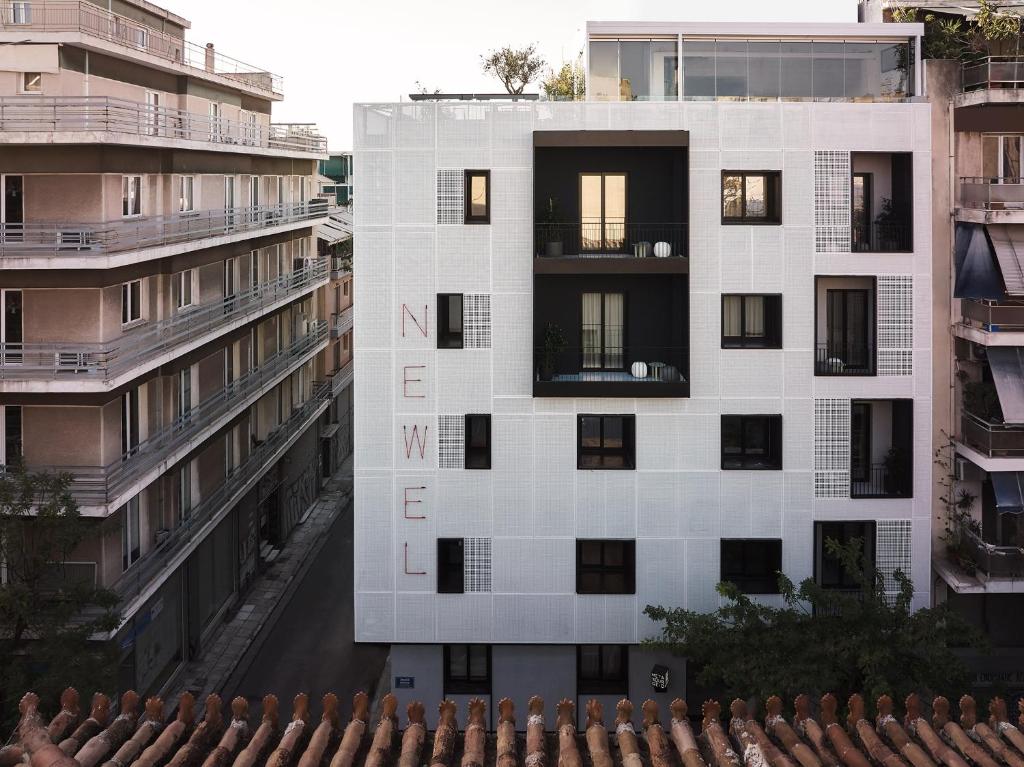 an aerial view of a white building with black windows at The Newel Metaxourgeio in Athens