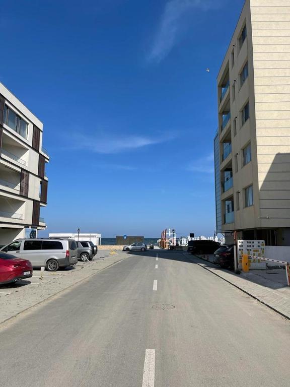 una calle vacía en un estacionamiento junto a un edificio en Apartament Aqua - Endless Summer Mamaia Nord Apartaments, en Mamaia Nord – Năvodari