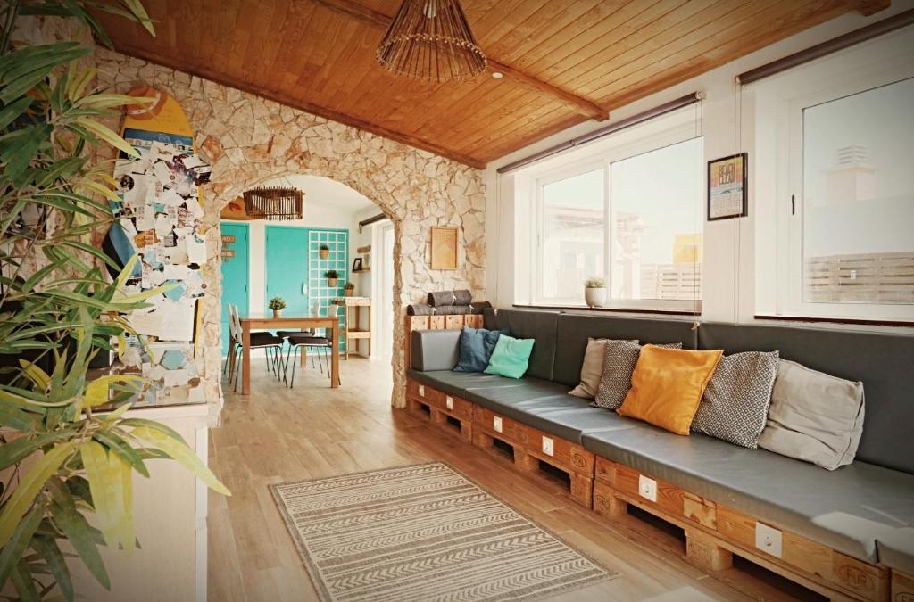 a living room with a couch and a table at International Surf School & Camp in Sagres