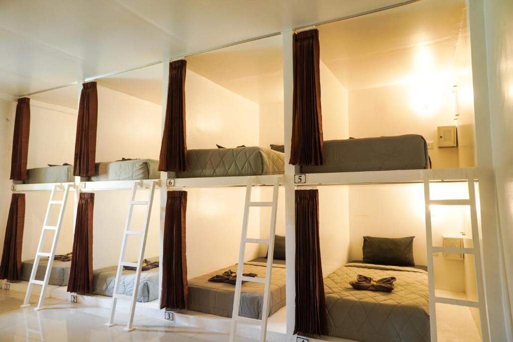 two bunk beds in a room with a mirror at Gypsy Lust Ubud in Ubud