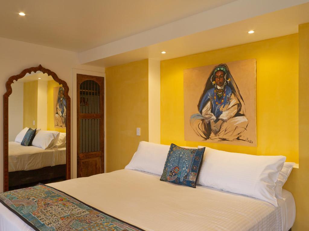 a bedroom with two beds and a painting on the wall at Panoramia Villas in Myrtleford