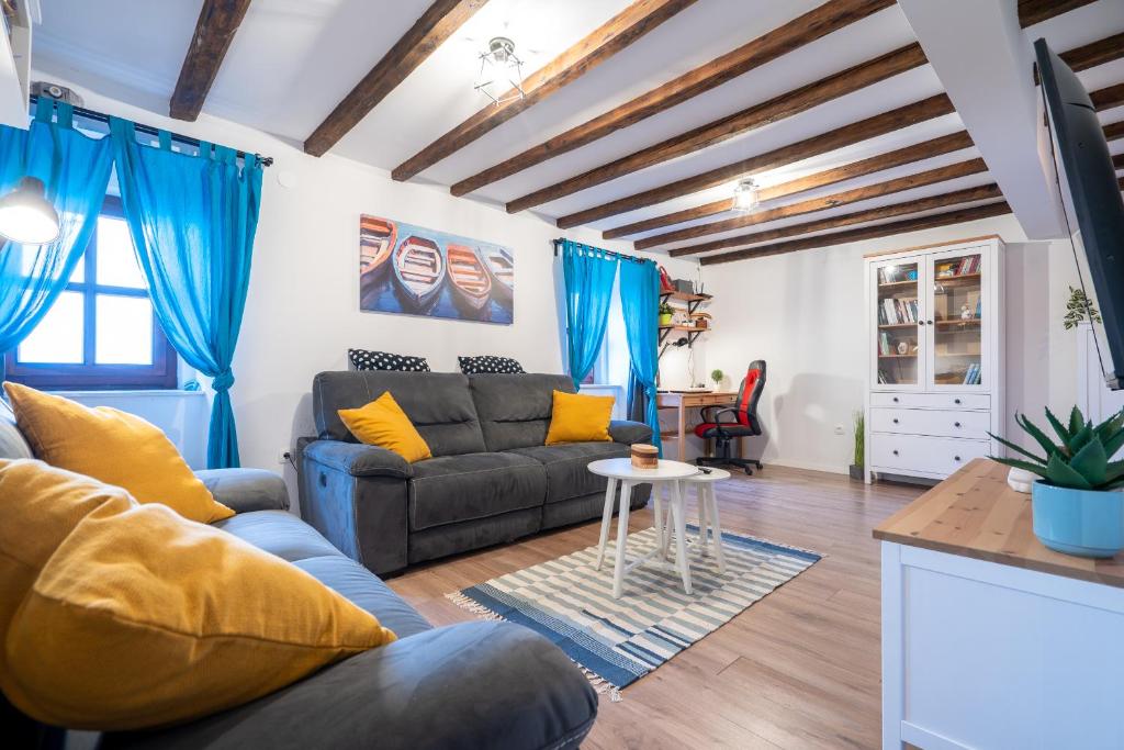 a living room with a couch and a table at Holiday House Nova in Stara Baška