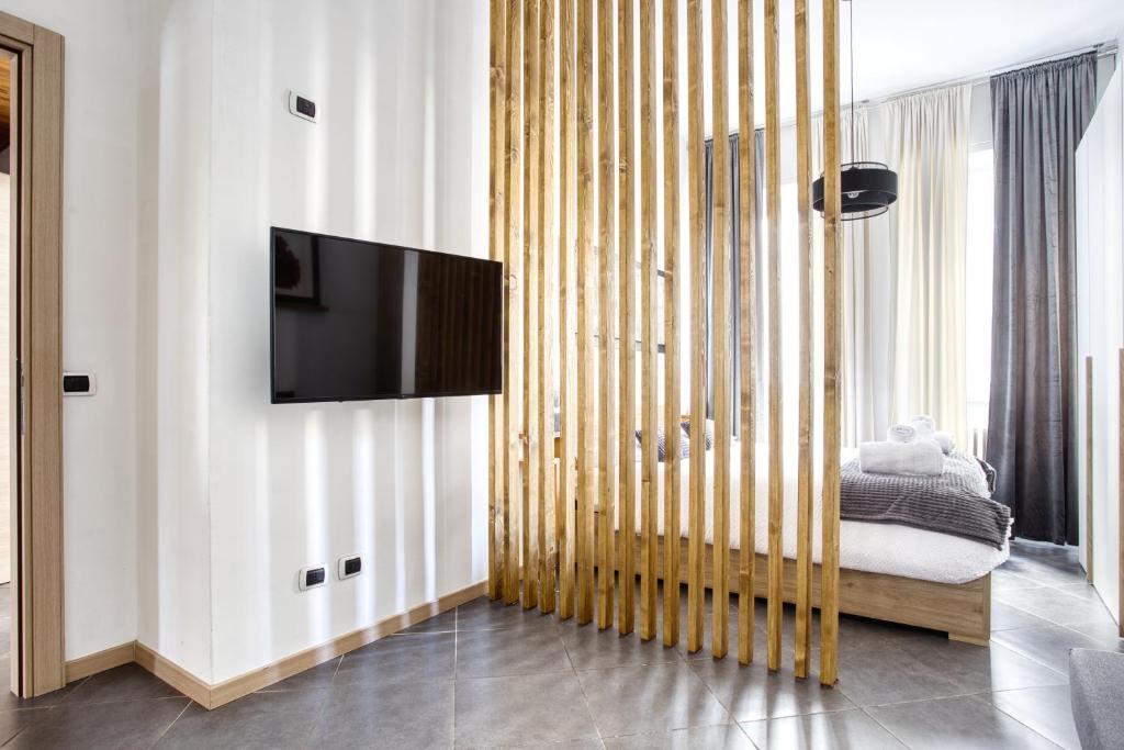 a living room with a tv on a wall at C Studio - Design Bilo Suite -M3- 8 min dal Duomo in Milan