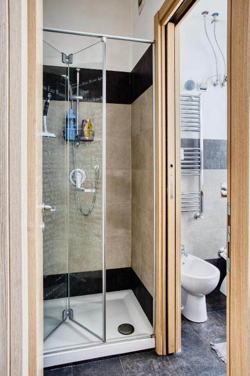 a shower with a glass door in a bathroom at C Studio - Design Bilo Suite -M3- 8 min dal Duomo in Milan