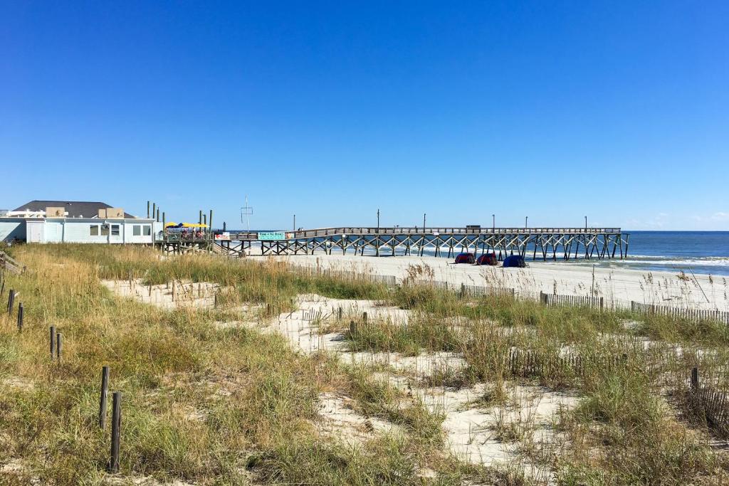 a beach with a pier and the ocean at Seaside Unit C in Myrtle Beach