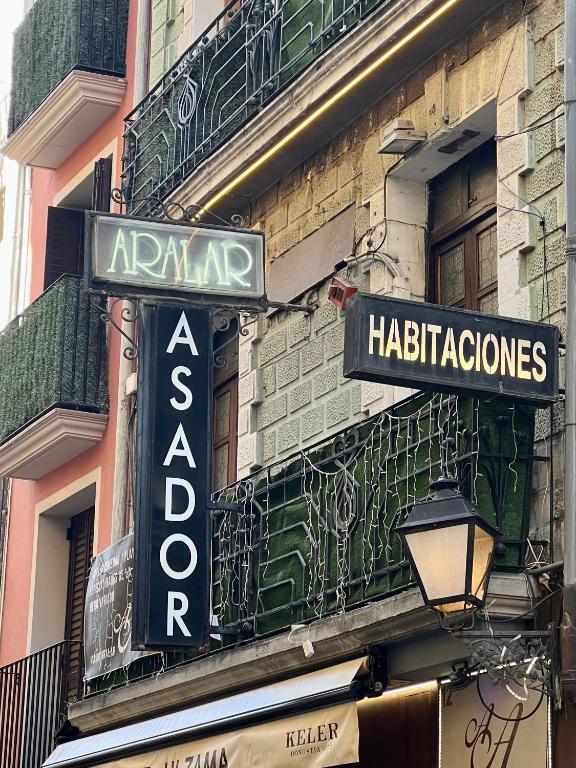 a sign for a restaurant on the side of a building at Hostal Restaurante in Pamplona