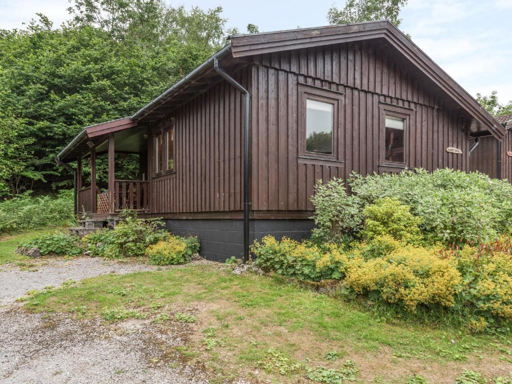 a small wooden house with a yard at Chalet No 2 in Skipton