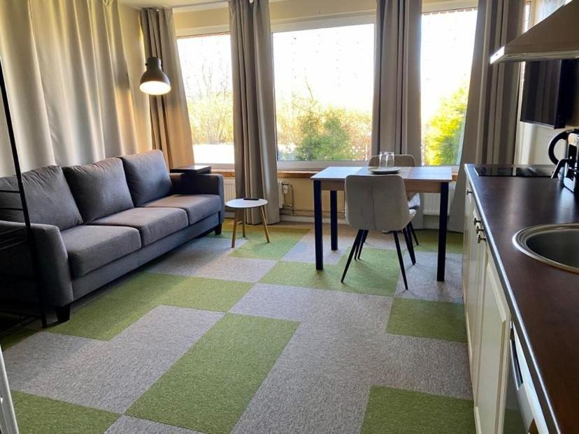 a living room with a couch and a table at Veeriku Villa in Tartu