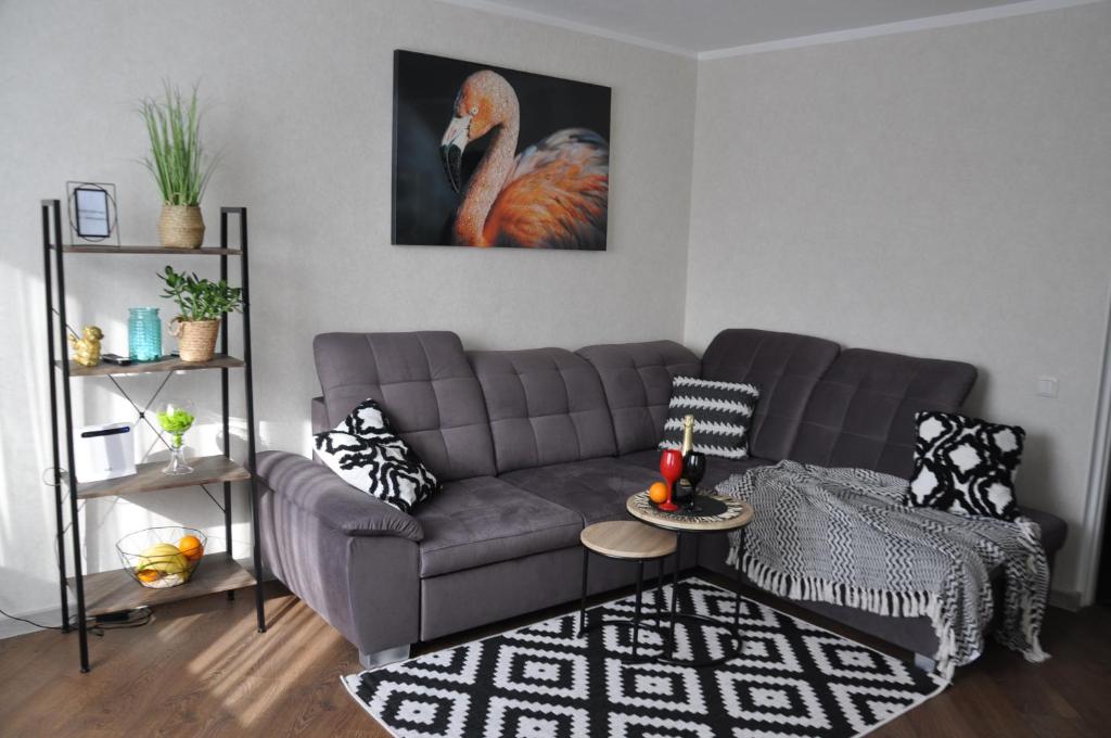 a living room with a couch and a picture of a bird at Lada Wings 2 in Narva
