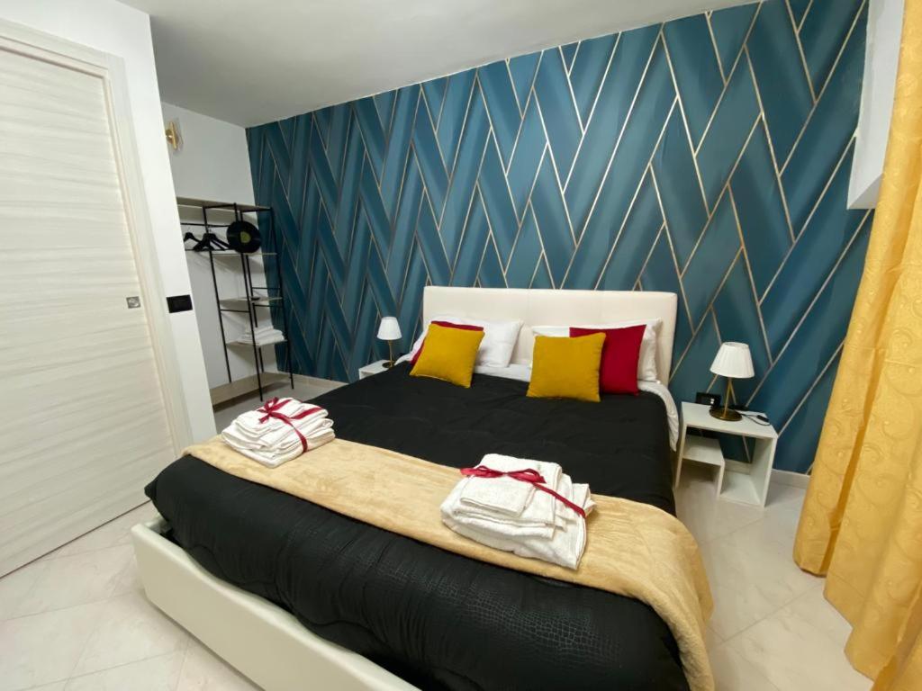 a bedroom with a large bed with towels on it at Pontecorvo Naples Apartament in Naples