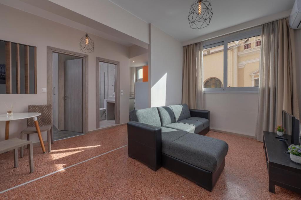 a living room with a couch and a table at Kosmos Service Apartment Absolute City Center 1-5 With Additional Cost Parking in Thessaloniki