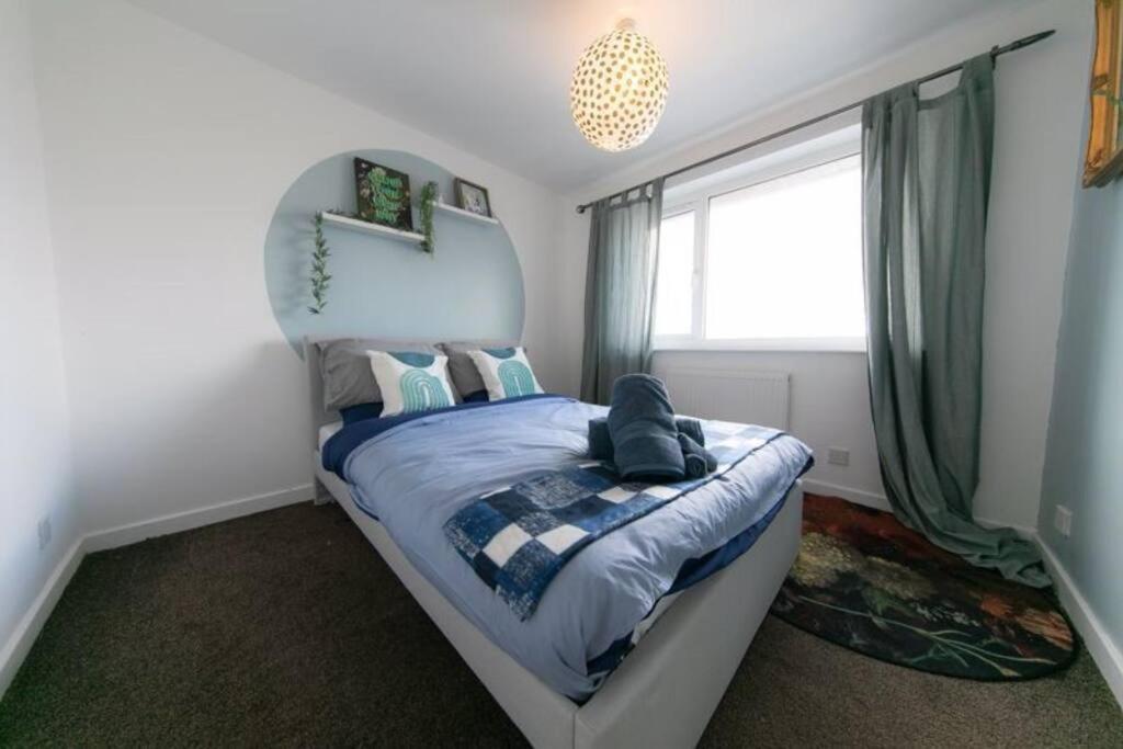 a bedroom with a bed and a window at Lancashire Living! in Preesall