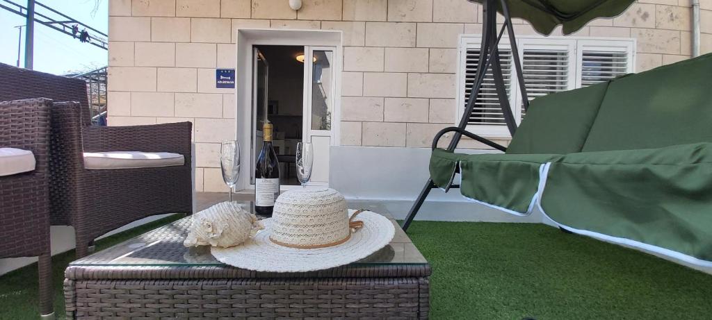 a straw hat sitting on a table on a patio at Apartment Mara in Dubrovnik