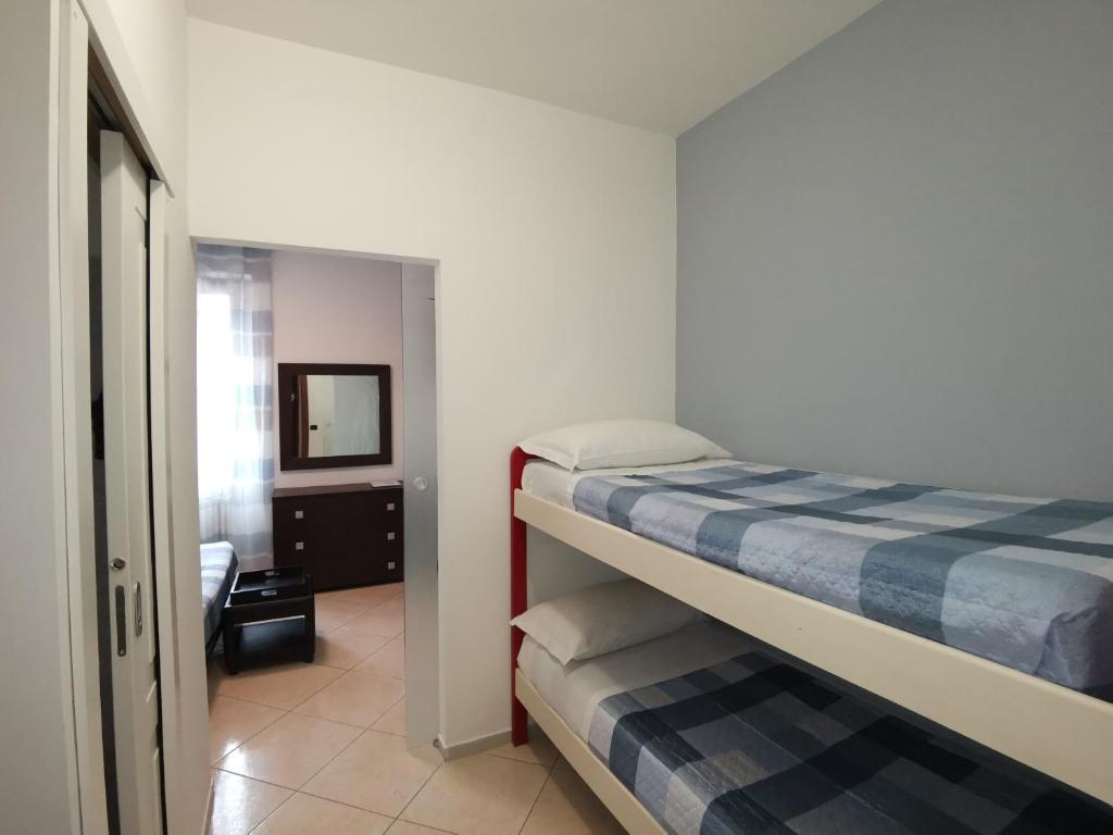 a bedroom with two bunk beds and a bathroom at BeB I PORTICI in Cernobbio