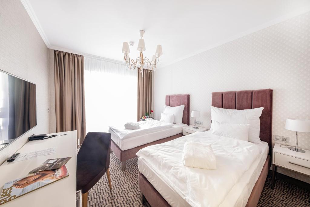 Postel nebo postele na pokoji v ubytování Spa Hotel ULRIKA