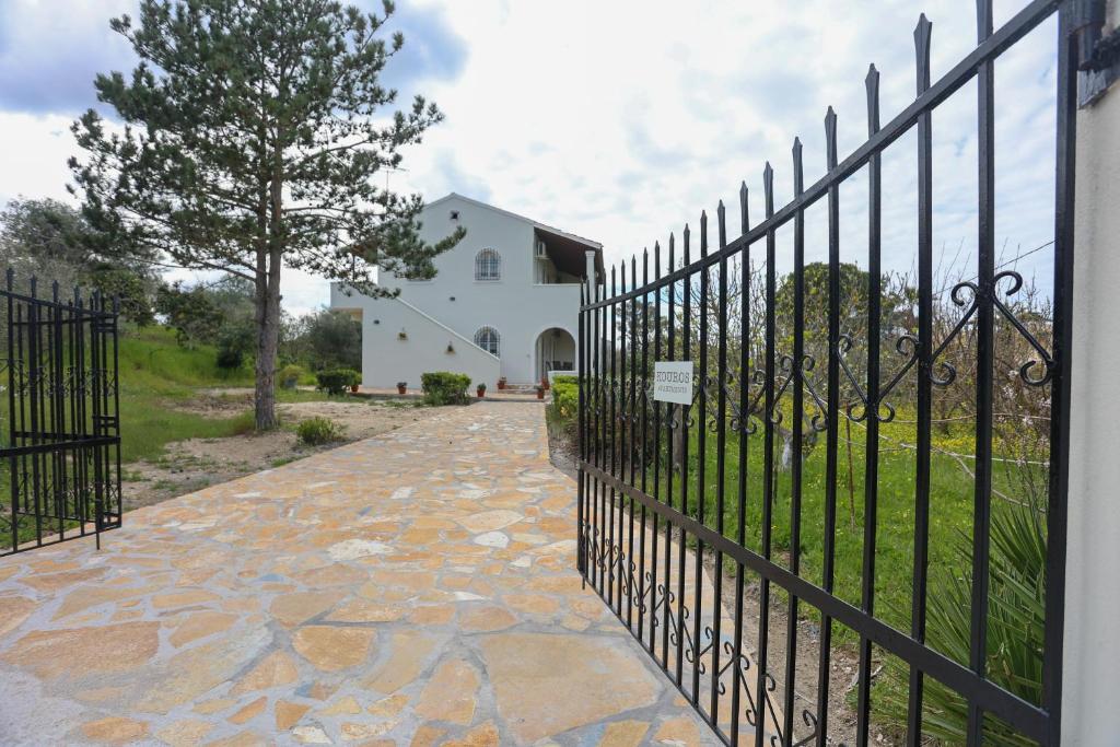 a wrought iron fence in front of a house at Kouros apartments in Litherés