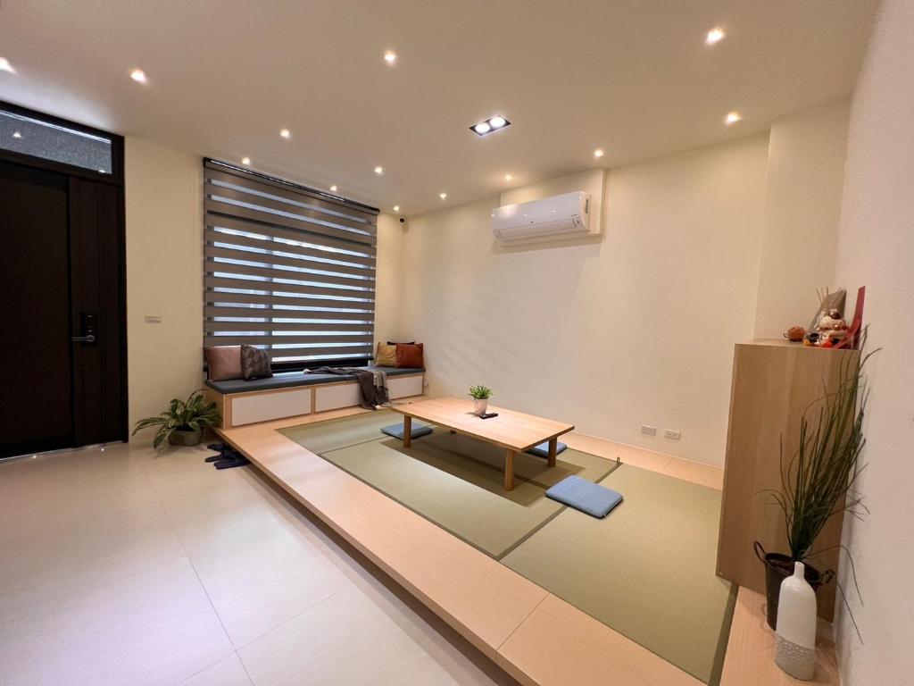 a living room with a table and a window at 懶得棟民宿 in Guanshan