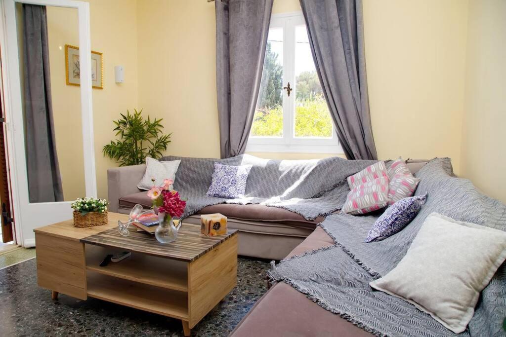 a living room with a couch and a coffee table at Spentza Home in Spetses