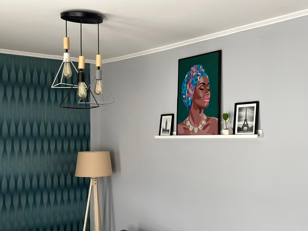 a room with a picture of a woman on a wall at Apartment TEATAR Tuzla in Tuzla