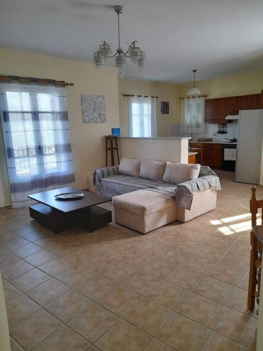a living room with a couch and a coffee table at SummerAndros Skalario in Andros