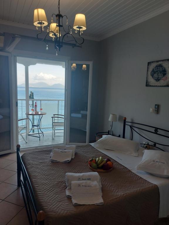 a bedroom with a bed with a view of the ocean at Romanza Studios in Vasiliki