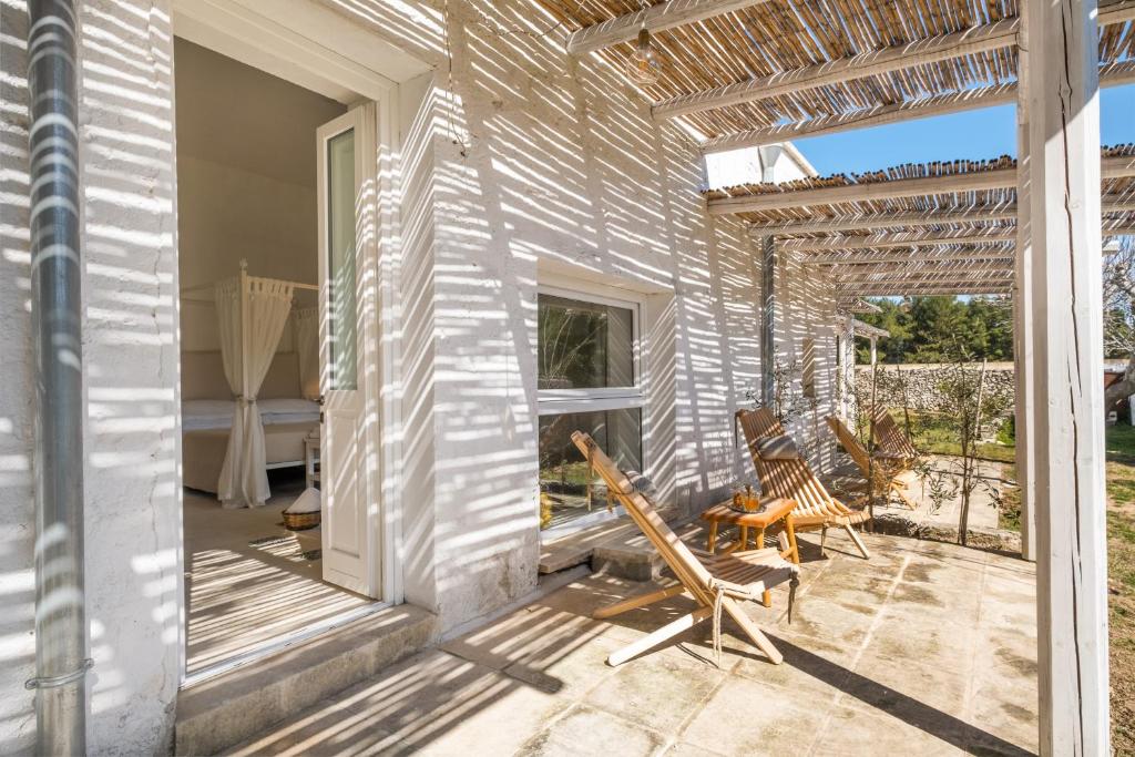 a patio with two chairs and a swing at Masseria Rauccio in Torre dell'Orso