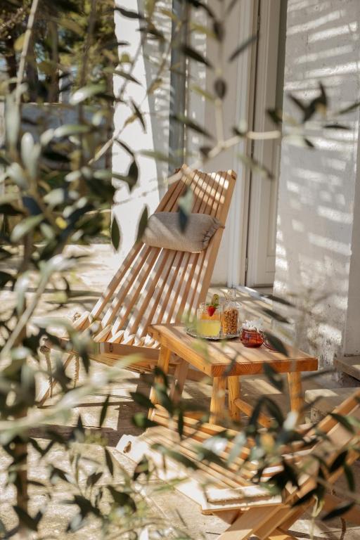 a wooden chair and a table on a porch at Masseria Rauccio in Torre dell'Orso