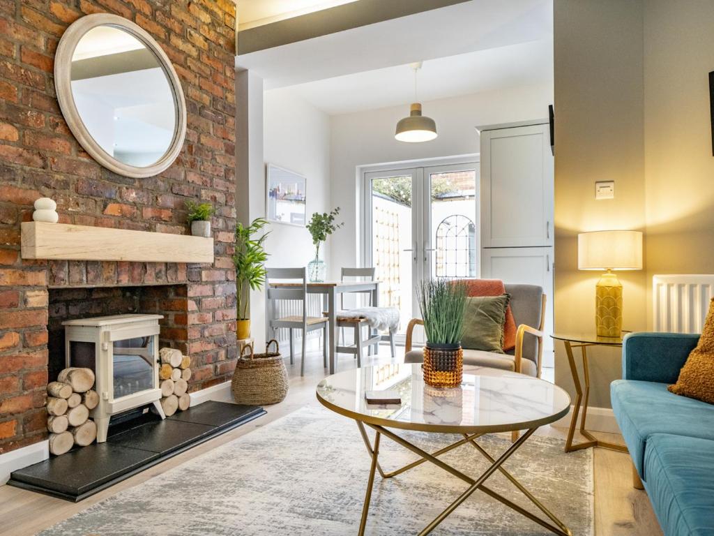 a living room with a fireplace and a brick wall at Pass the Keys Rathcool Gorgeous Terrace with Outdoor Living Cafes and Bars in Belfast