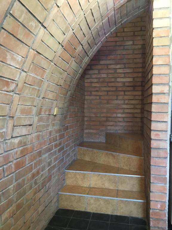 a brick archway with stairs in a brick wall at Sklep u Dušana in Vracov