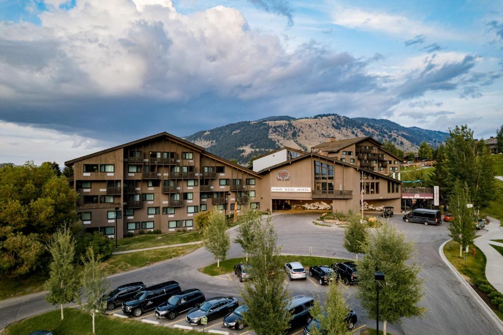 an aerial view of a hotel with cars parked in a parking lot at Snow King Resort in Jackson