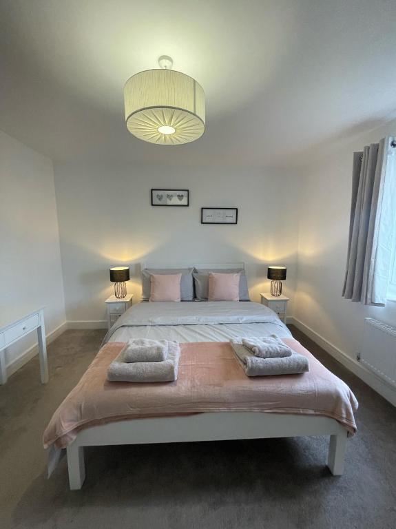 a bedroom with a large bed with pillows on it at The Rita House in Doncaster