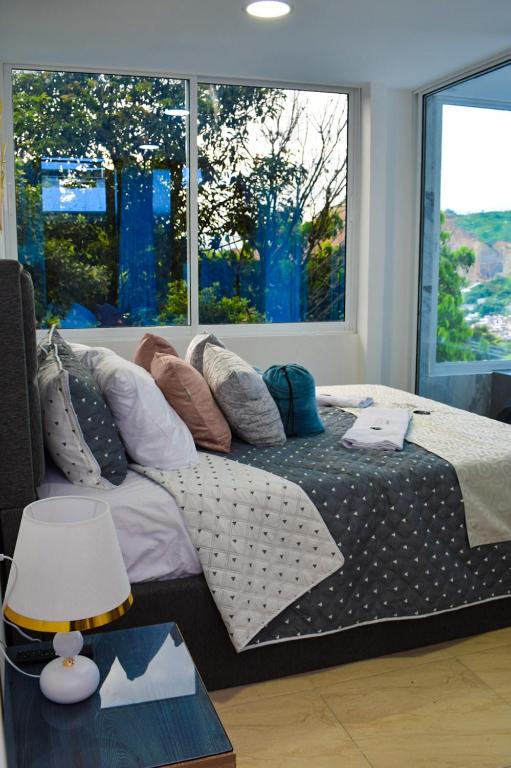 Postel nebo postele na pokoji v ubytování Ayenda Ceiba Rooms
