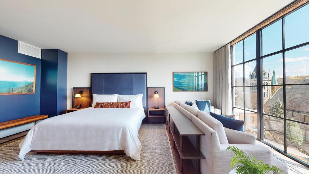 a bedroom with a large bed and a large window at The Restoration Asheville in Asheville