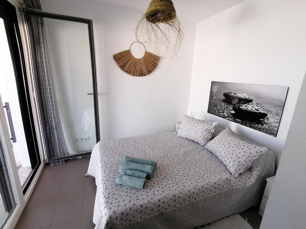 a bedroom with a bed with two pillows on it at Apartamento Viento Del Sur in Las Negras