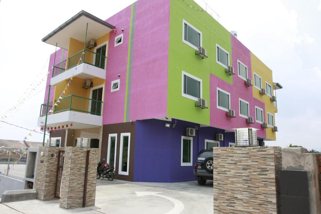 a brightly colored building with a car parked in front at Alor Villa in Malacca