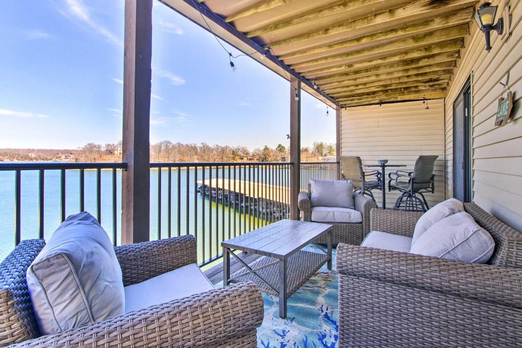 a patio with chairs and a table on a balcony at Osage Beach Resort Condo with Community Pool! in Osage Beach